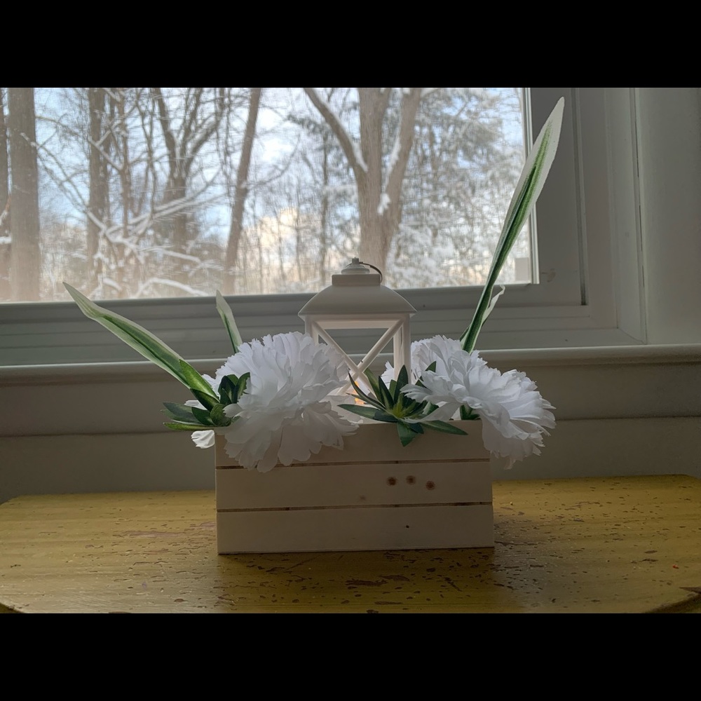 Crate and lantern centerpiece with foliage